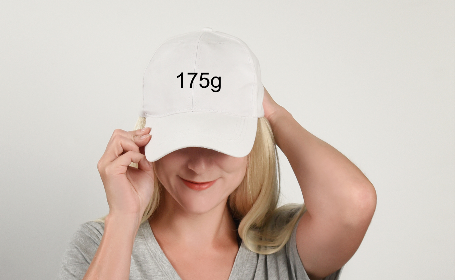 a woman wearing a white 175 gram hat embroidered hat ultimate frisbee