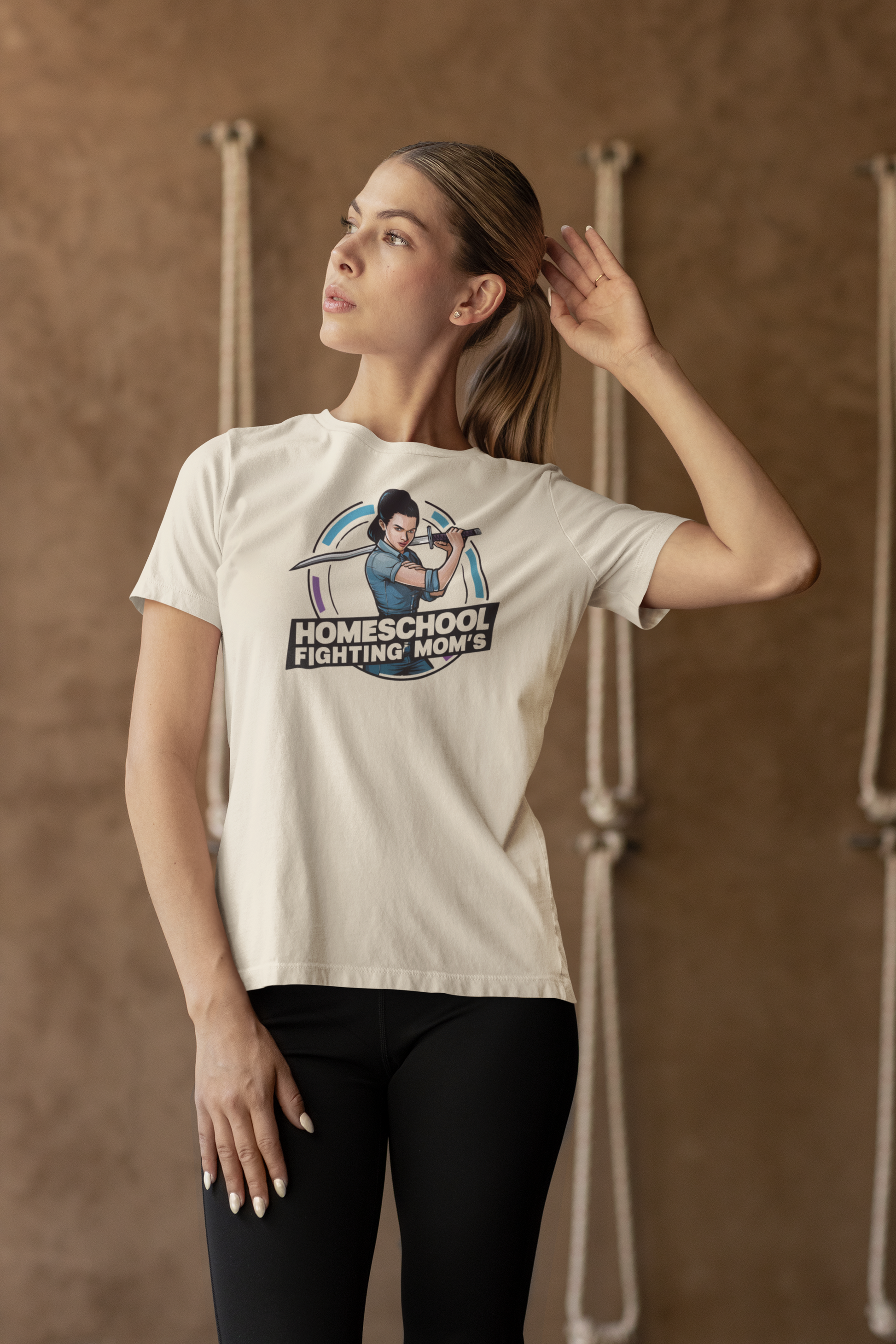 a woman in a gym wearing a warrion fighting mom's t-shirt