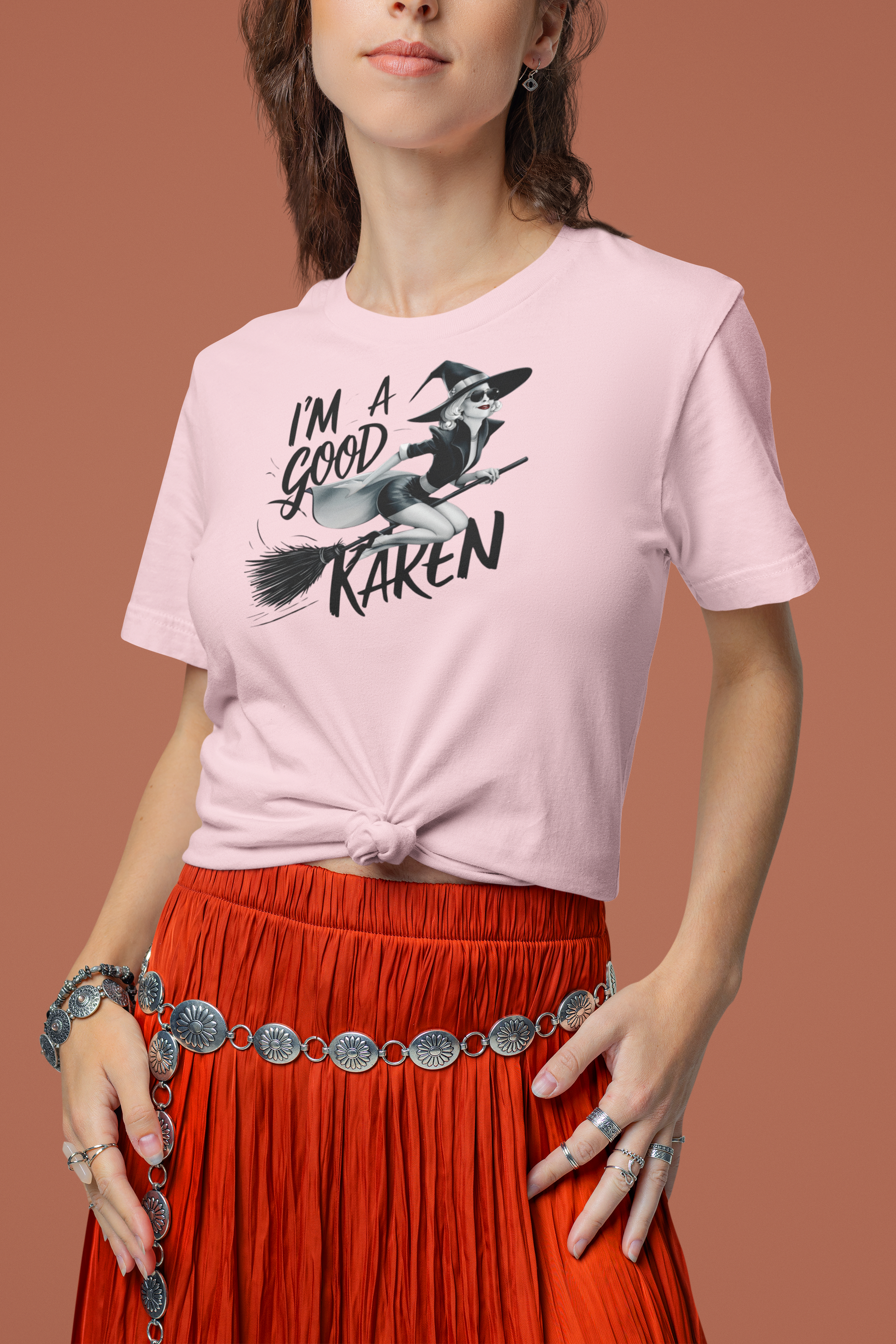 a woman sporting  t shirt with a fun loving witch on a broom with the caption I'm A Good Karen
