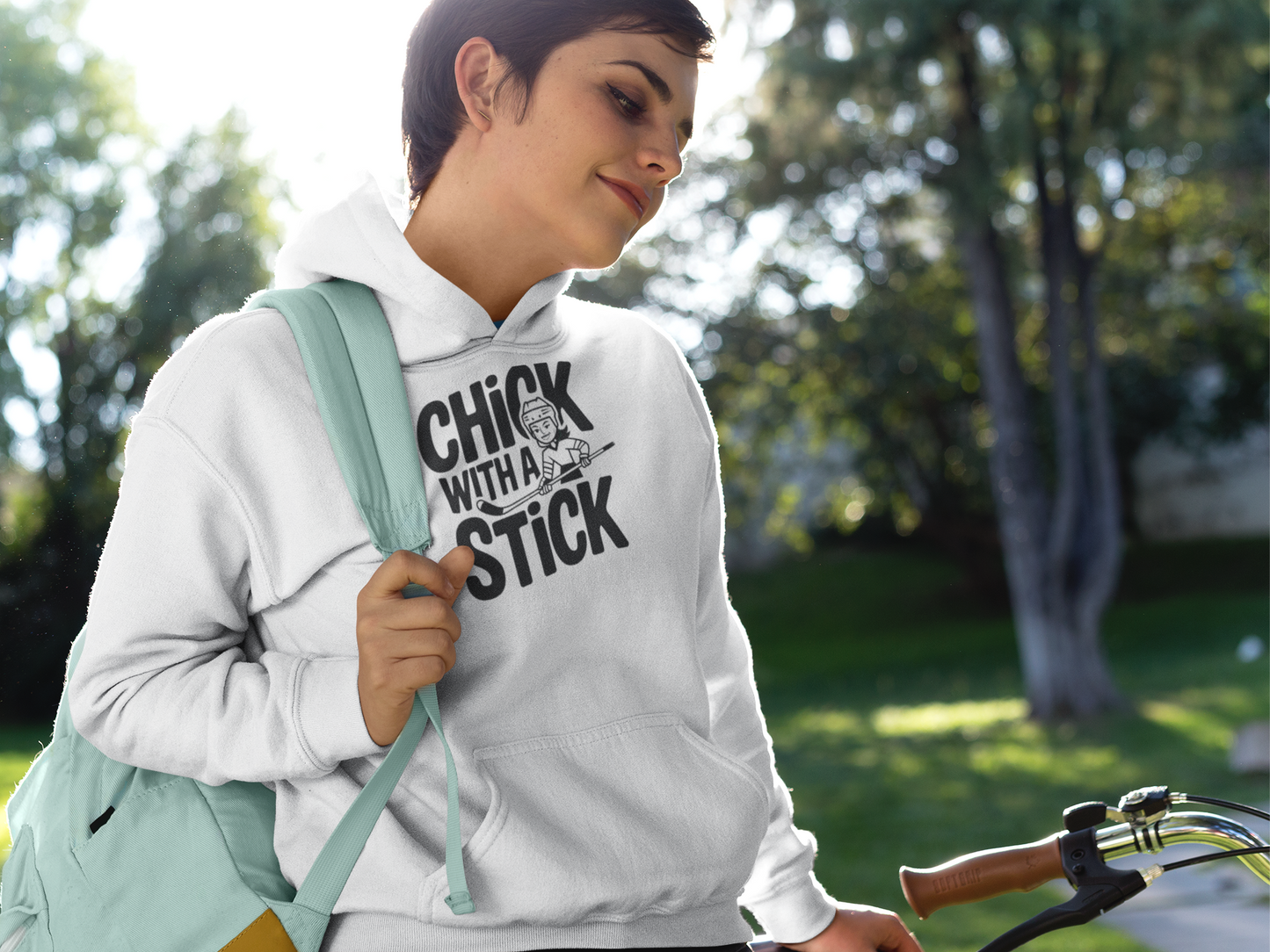a woman sporting A hoodies with the hockey slogan Chick With A Stick