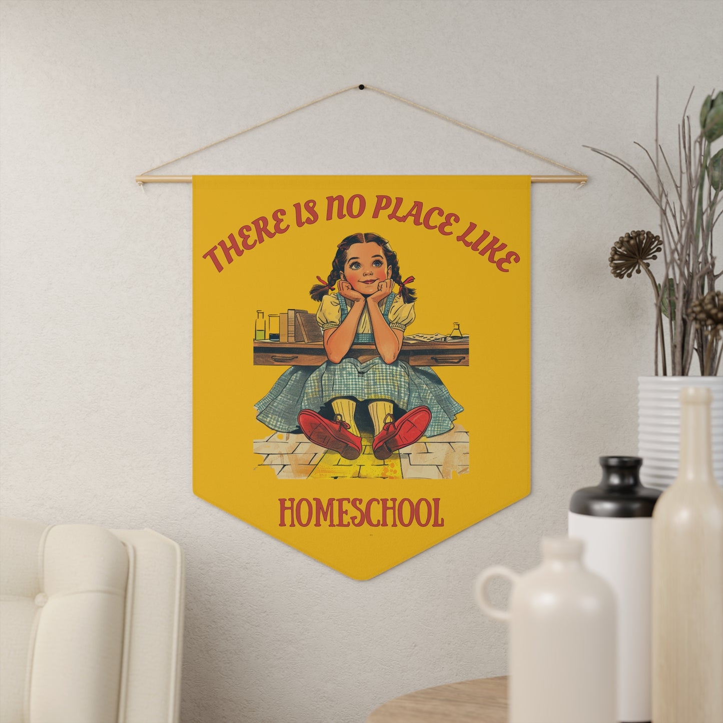 a yellow pennant on a living room wall. the pennant has the caption There is no place like homeschool