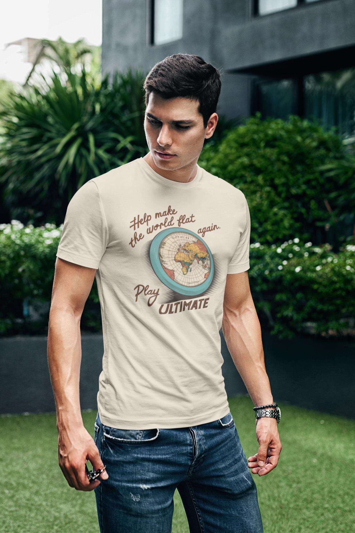 a man sporting a t-shirt with a flying frisbee of the world printed on it with the caption Help Make The World Flat Again Play Ultimate