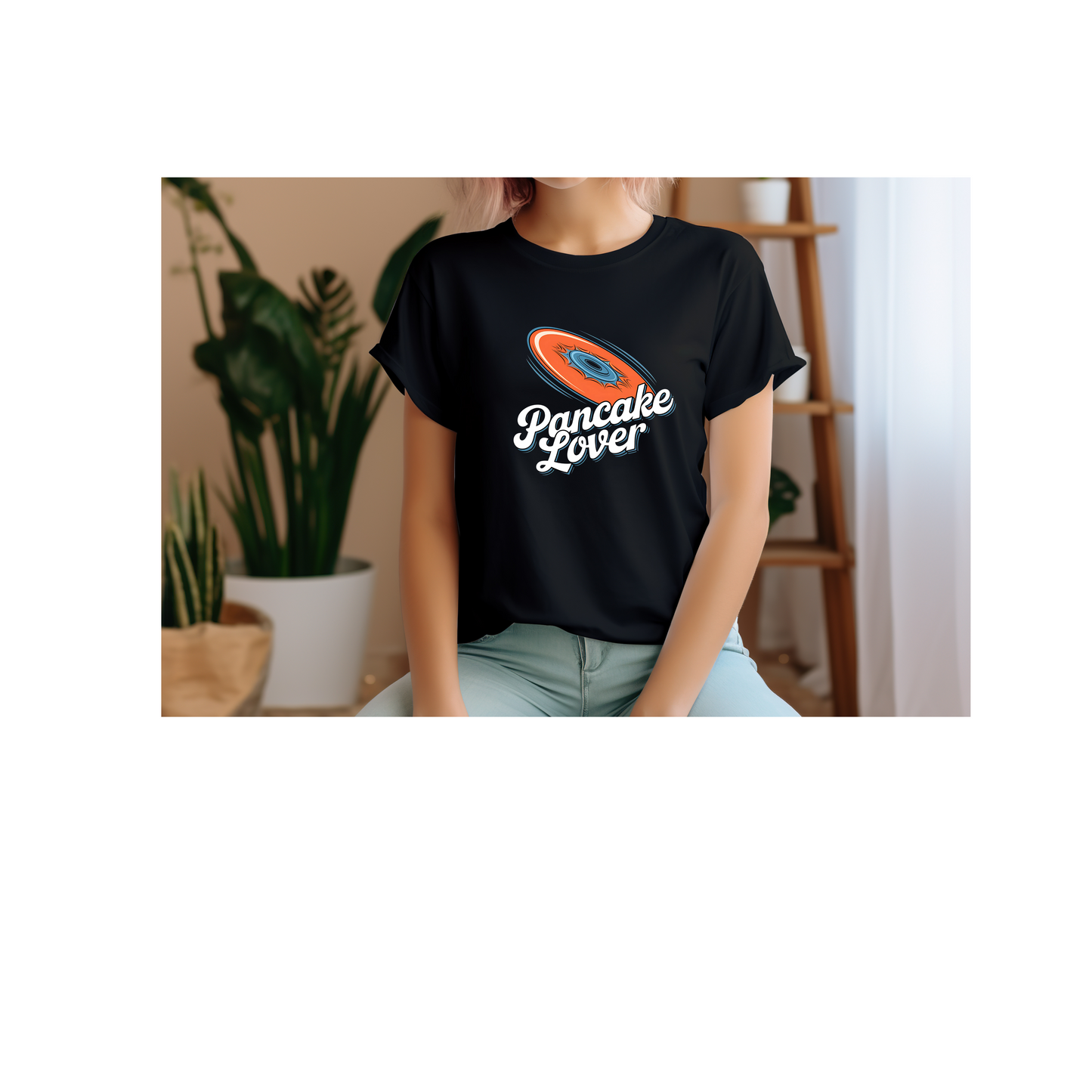 a young woman wearing a black Pancake Lover Ultimate frisbee shirt featuring a flying pancake in retro design lettering
