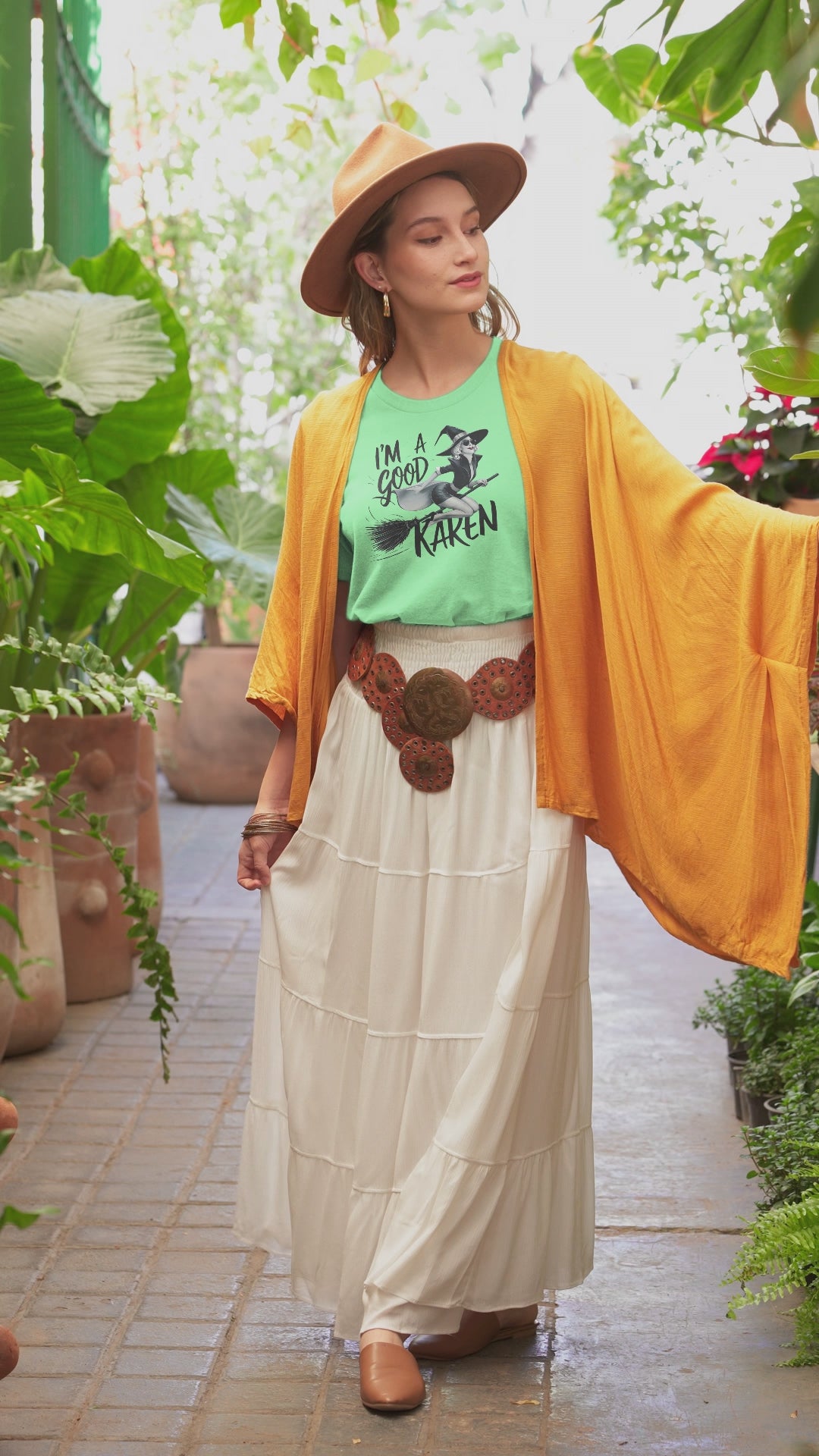 a video with a young woman sporting t shirt with a fun loving witch on a broom with the caption I'm A Good Karen