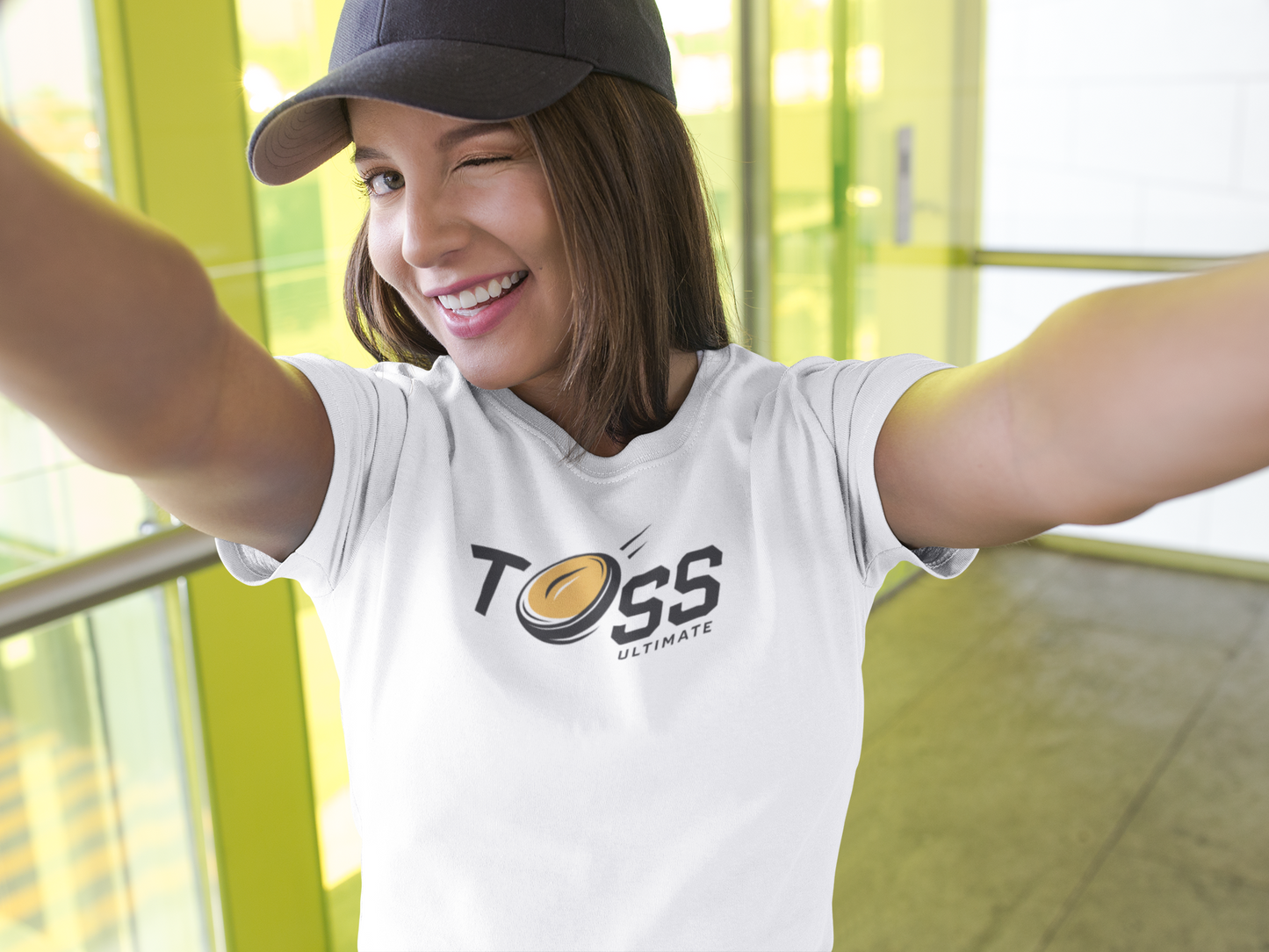 a young woman wearing Toss Ultimate Frisbee Company Shirt featuring flying frisbee in logo