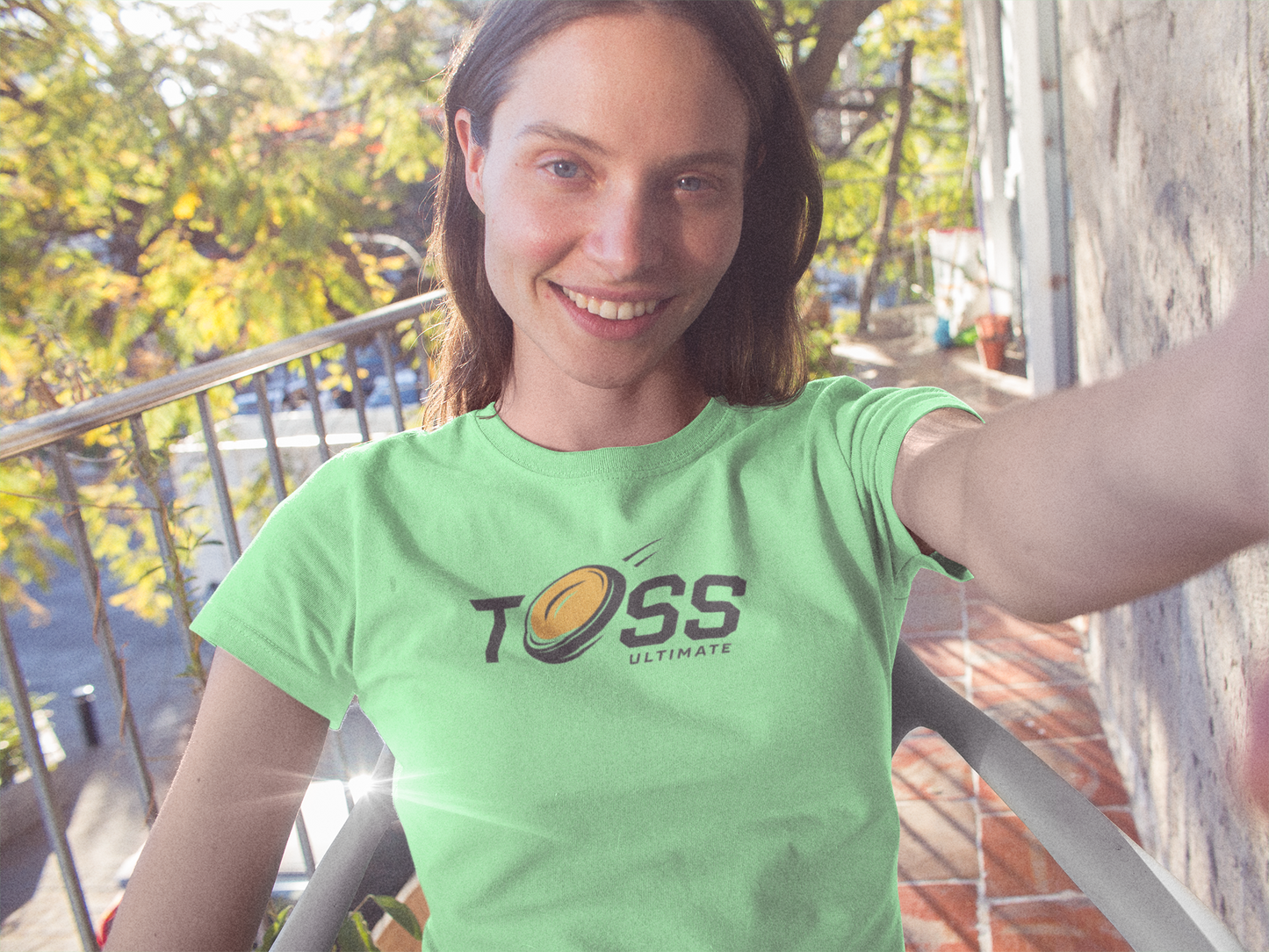 a hip woman wearing Toss Ultimate Frisbee Company Shirt featuring flying frisbee in logo