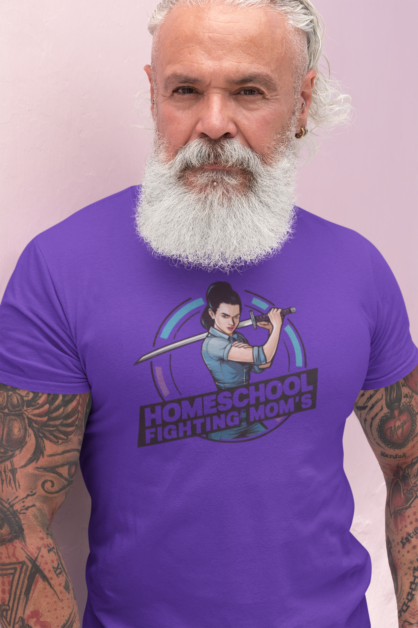 a senior man wearing a shirt with a modern woman brandishing a sword with the logo Homeschool Fighing Mom's