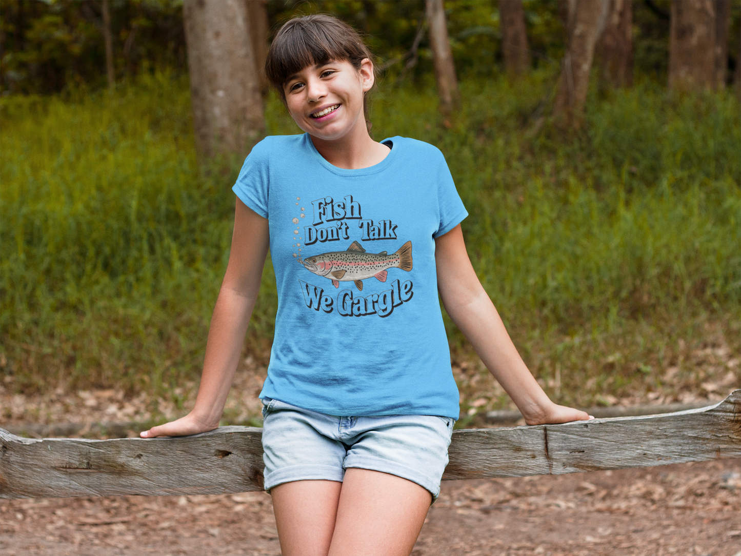 a cool girl on a log sporting a love of Fish Don't Talk We Gargle Fish Gift Shirt