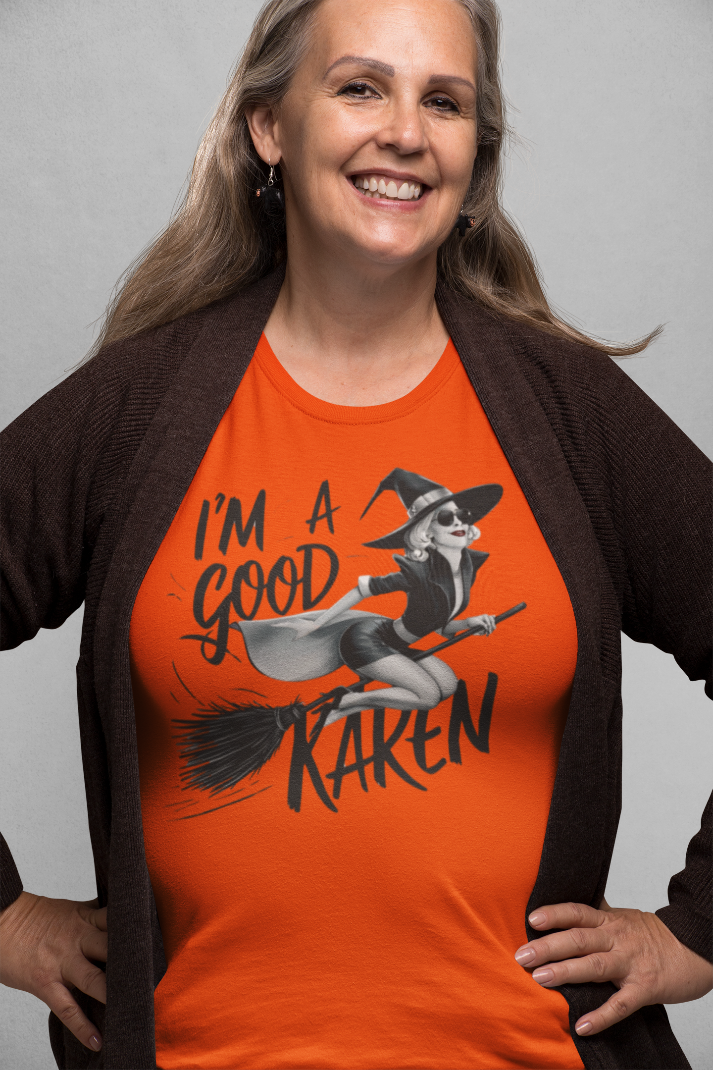 a mature woman sporting a t shirt with a fun loving witch on a broom with the caption I'm A Good Karen