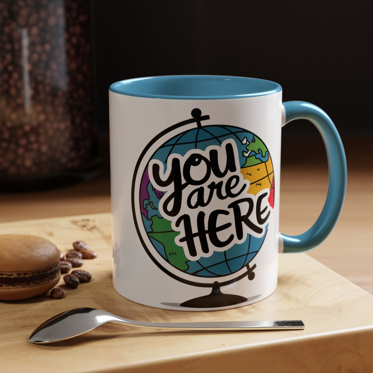 a mug with a picture of a globe with the caption you are here