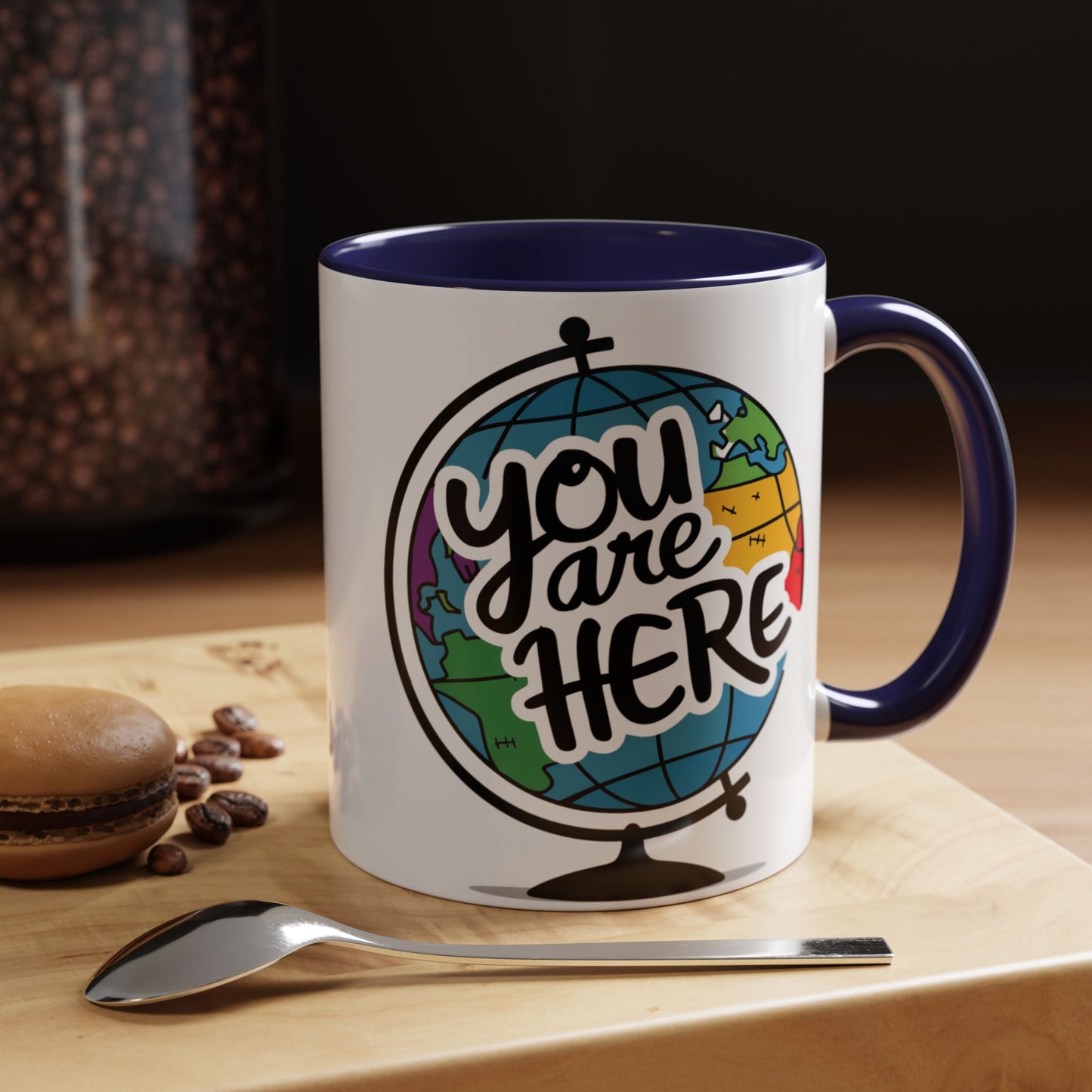 a mug with a picture of a globe with the caption you are here