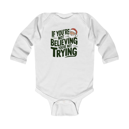 Baby in christmas onesie wearing a If you're not beieving you're not trying onesie onsie