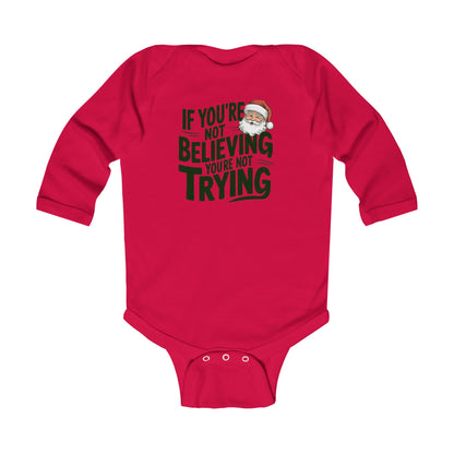 Baby in christmas onesie wearing a If you're not beieving you're not trying onesie Santa fan shirt
