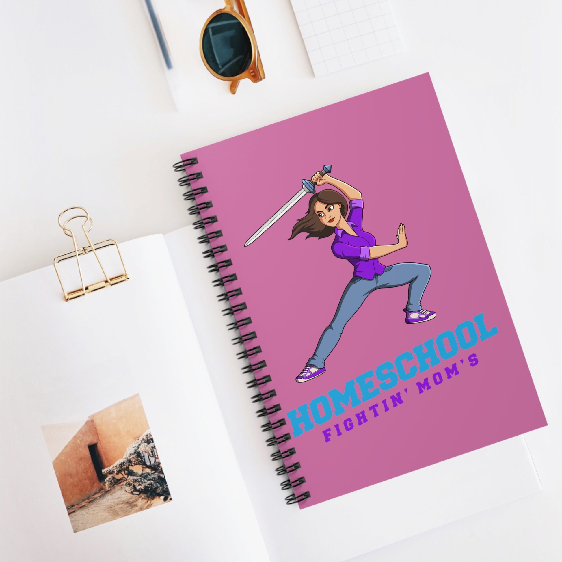 A pink notebook with cartoon warrior with the slogan homeschool fightiin mom's 