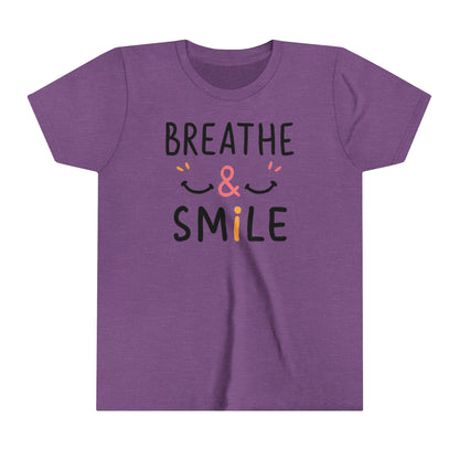  a t-shirt with the caption Breathe & Smile. two smile faces adore the caption