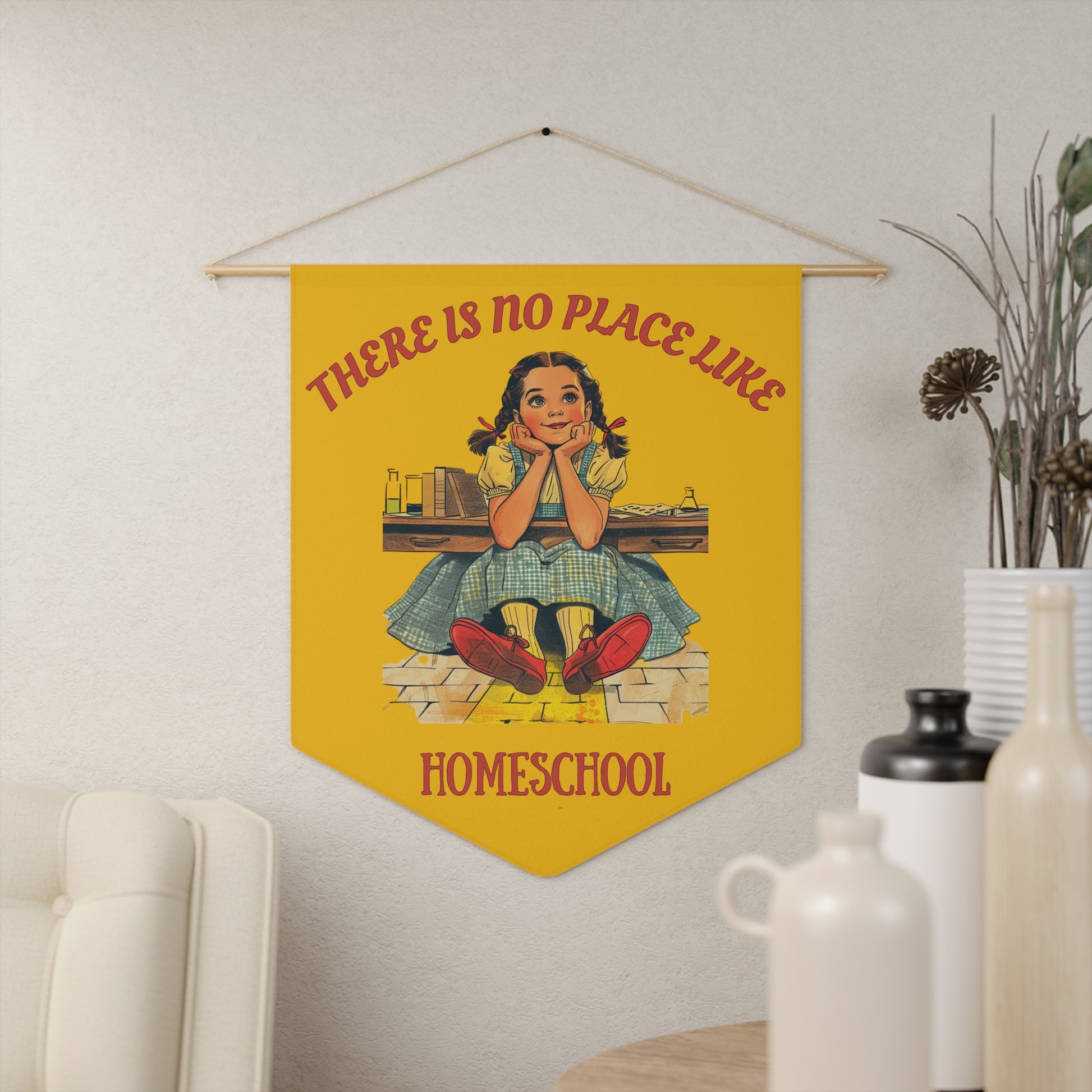 a yellow pennant on a living room wall. the pennant has the caption There is no place like homeschool