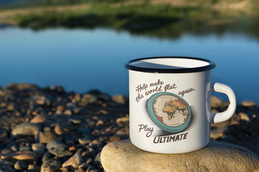 a white campers mug on the river&#39;s shore with the words Help Make The World Flat Again favorite frisbee gift