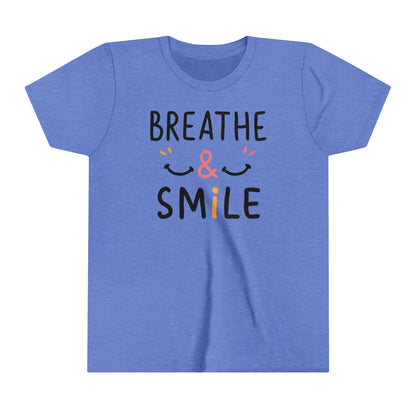  a t-shirt with the caption Breathe & Smile. two smile faces adore the caption