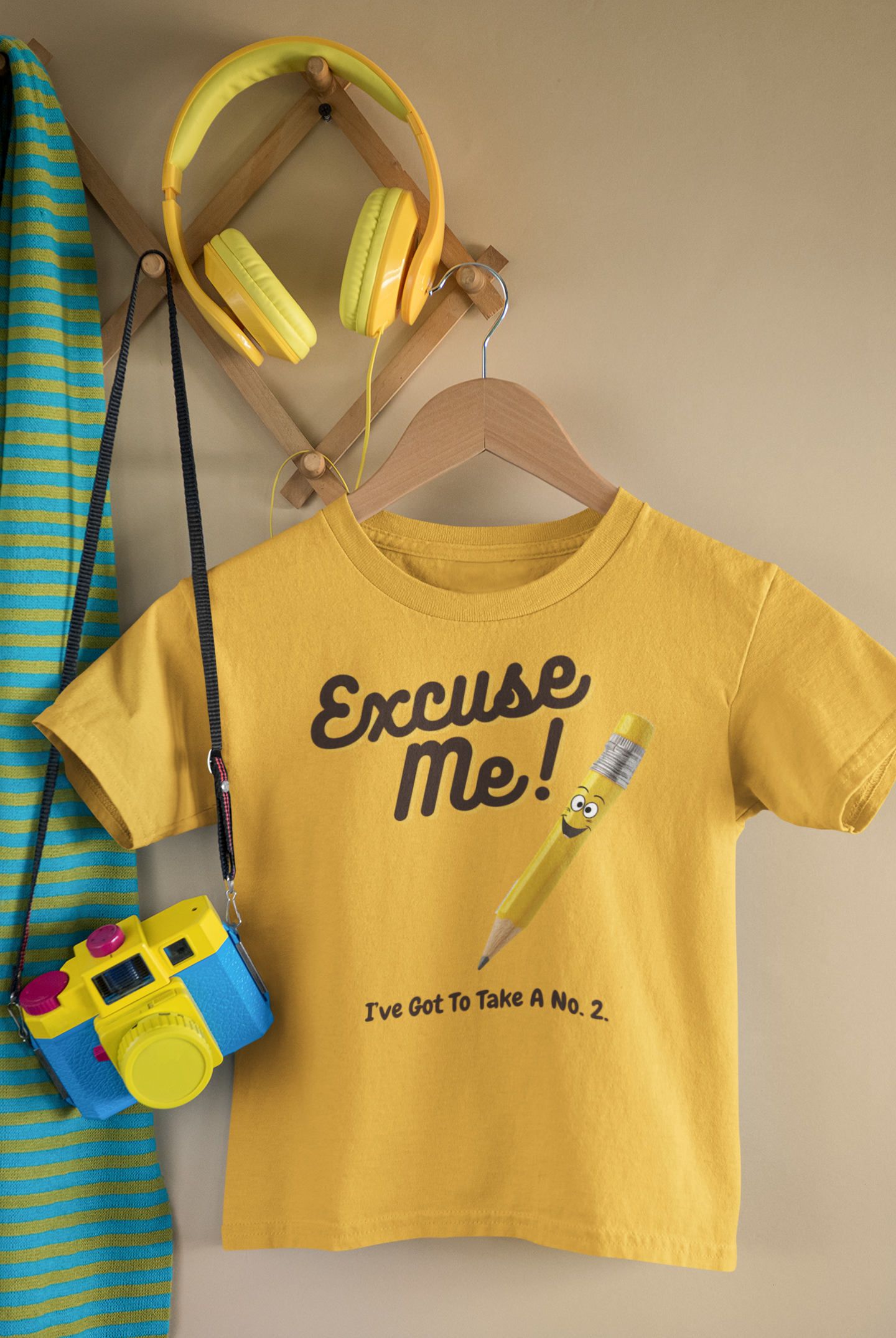  a t-shirt with the caption Excuse Me I've Got To Take A No.2. There is an illustrative smiling pencil alongside him