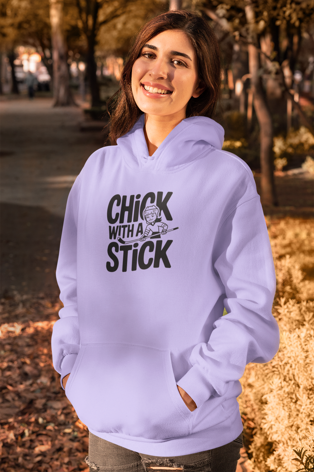 a fashionable woman sporting A hoodies with the hockey slogan Chick With A Stick