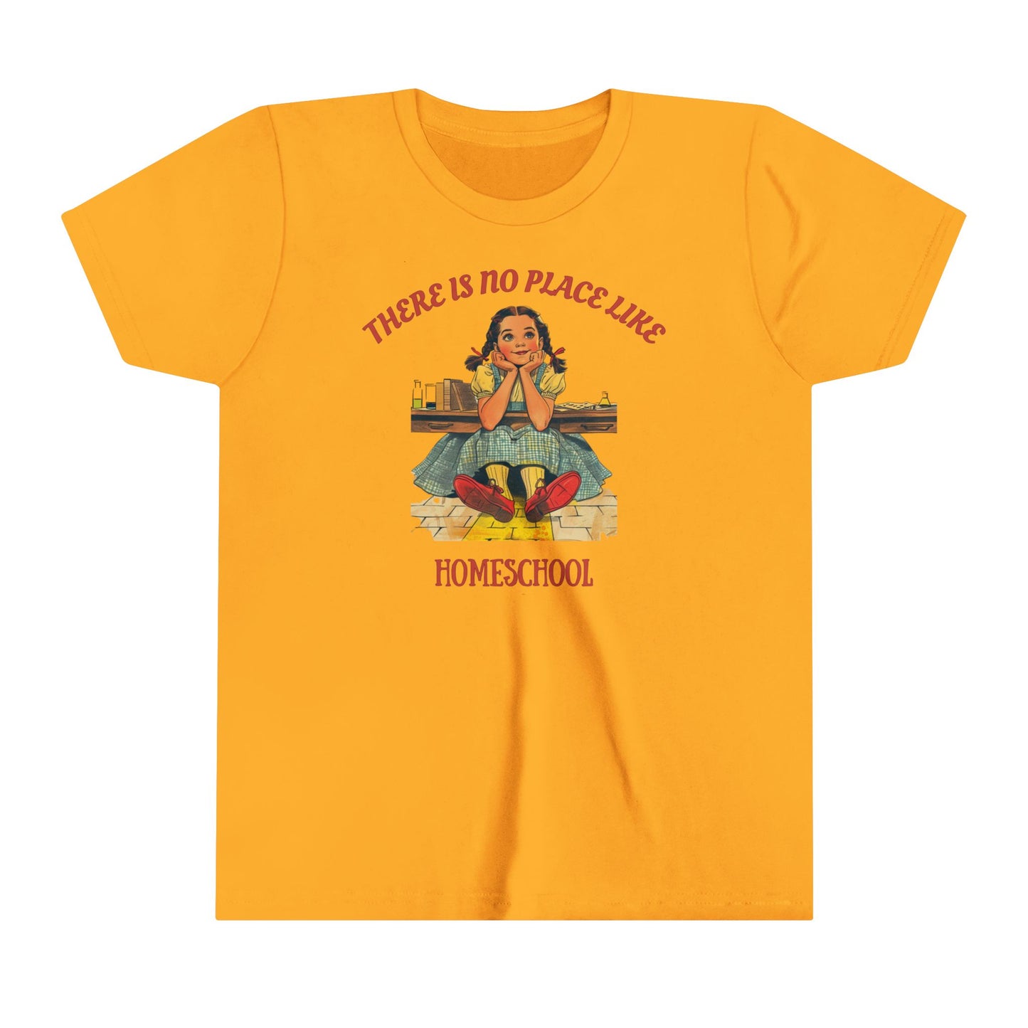 a kids t shirt a girl smiling above golden bricks with the slogan there is no place like homeschool