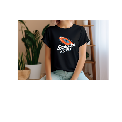 a young woman wearing a black Pancake Lover Ultimate frisbee shirt featuring a flying pancake in retro design lettering