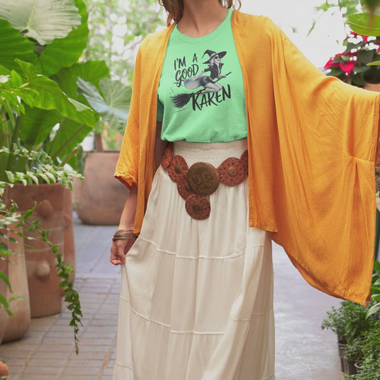 a video with a young woman sporting t shirt with a fun loving witch on a broom with the caption I'm A Good Karen