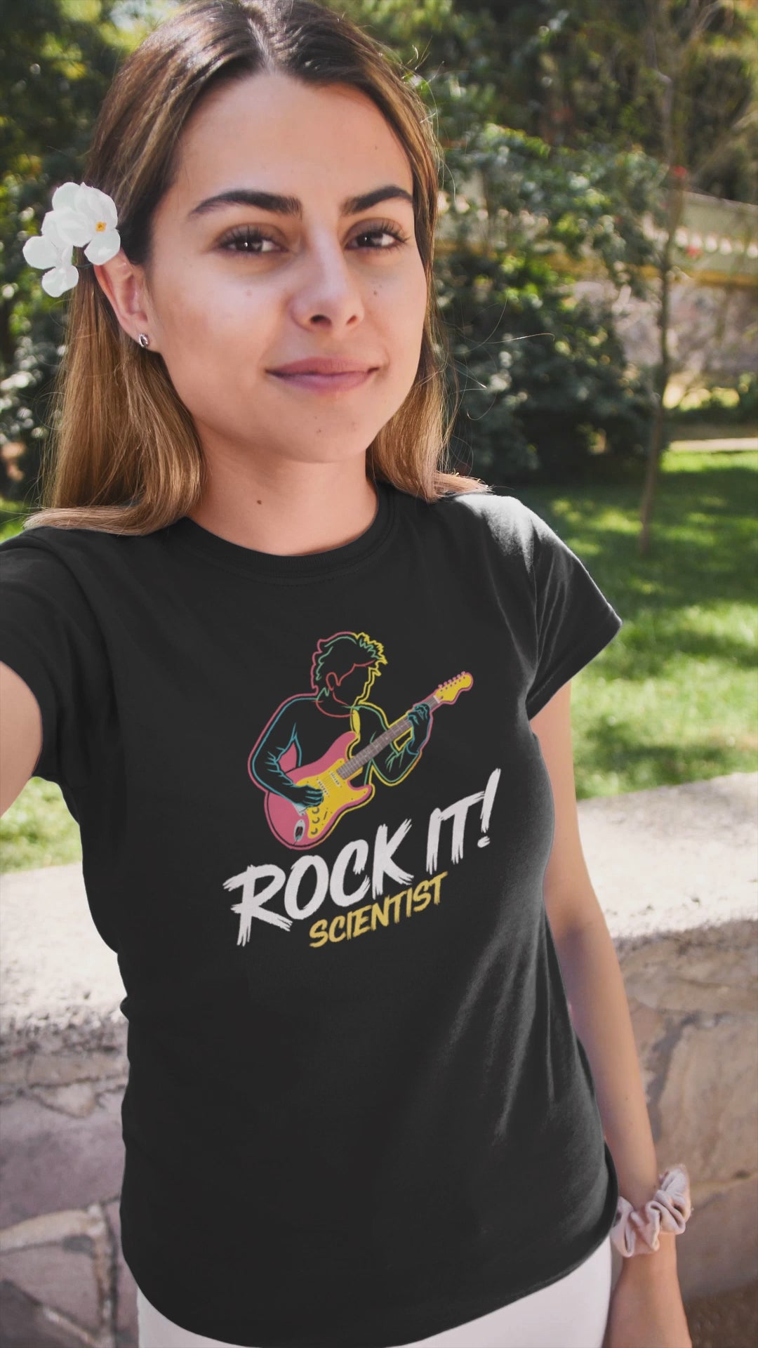 a video of young cool woman wearing A t-shirt with rock star jamming with the slogan Rock It Scientist