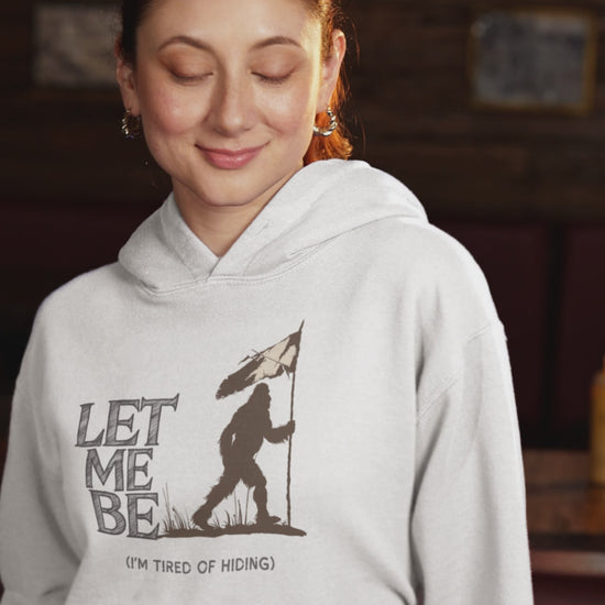 a video of a woman sporting a hoodie with bigfoot surrendering with white flag with the caption Let Me Be I'm Tired Of Hiding