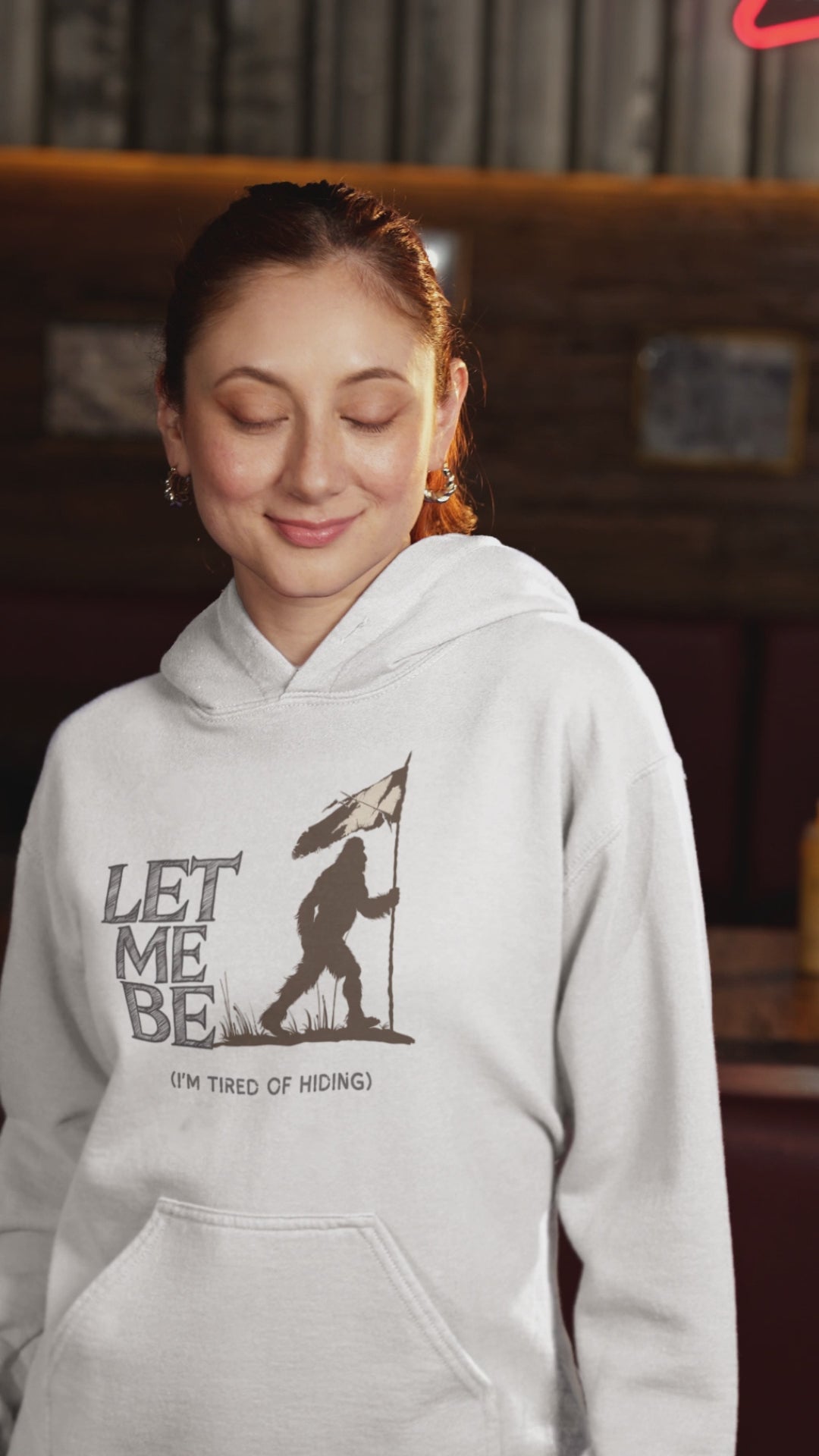 a video of a woman sporting a hoodie with bigfoot surrendering with white flag with the caption Let Me Be I'm Tired Of Hiding