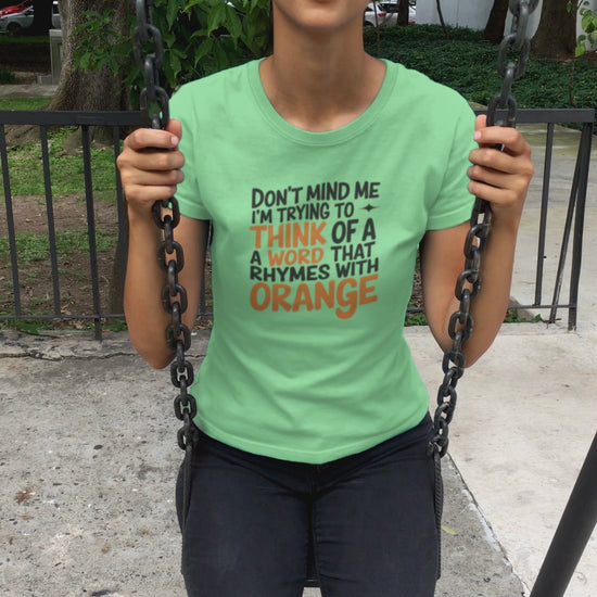 a video of pretty girl on swing wearing a quirky Don't Mind Me I'm thinking Of Orange funny t-shirt