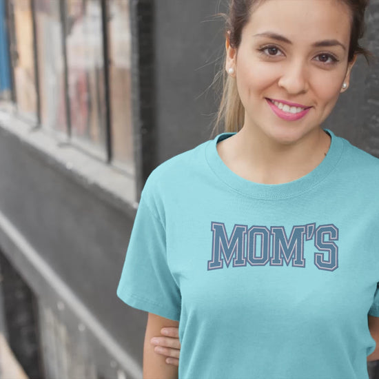 a video with young woman wearing a collegiate style logo with the caption Mom's