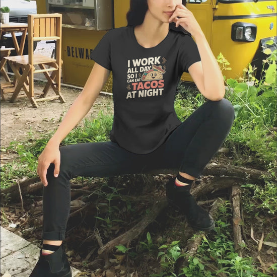 a video of woman sportaing a taco night shirt with the words I Work All Day So I Can Eat Tacos At Night Taco Tuesday T-Shirt