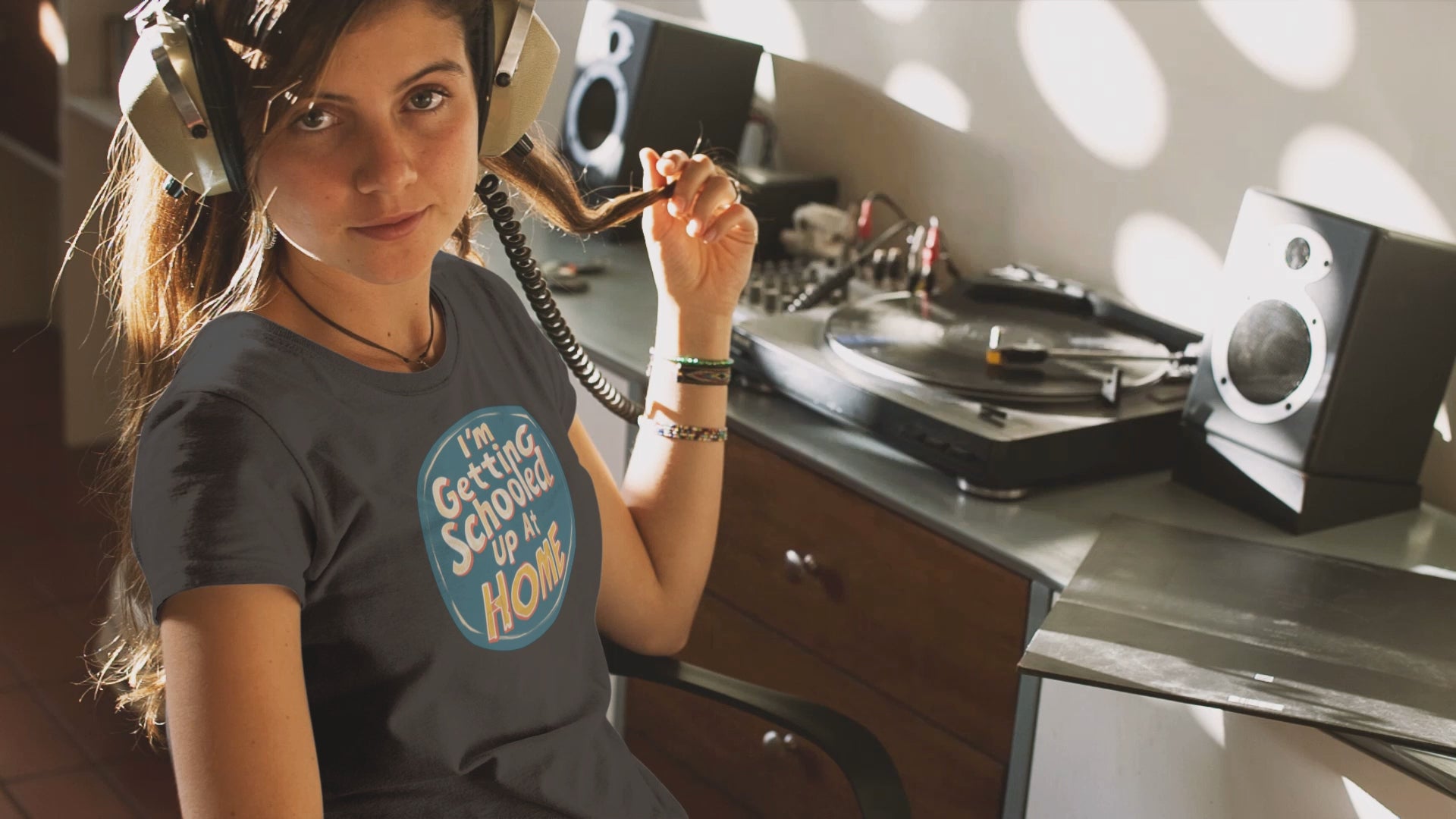 a young woman video wearing a t shirt a retro design shirt with the logo I'm Getting Schooled Up At Home 