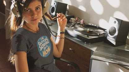 a young woman video wearing a t shirt a retro design shirt with the logo I'm Getting Schooled Up At Home 