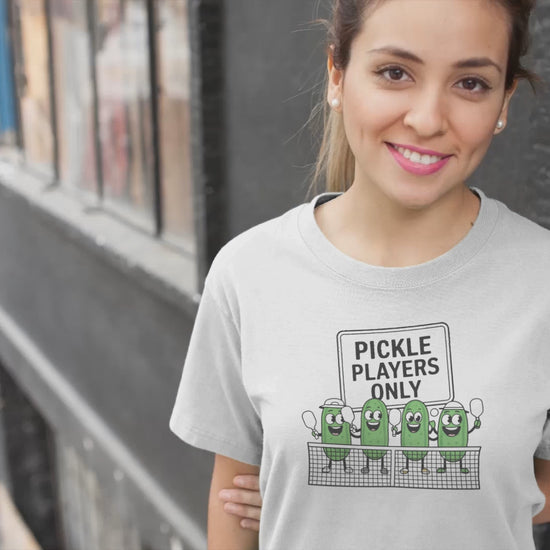 a video with a woman sporting a t shirt with pickles lined up playing pickleball with the slogan Pickle Players Only