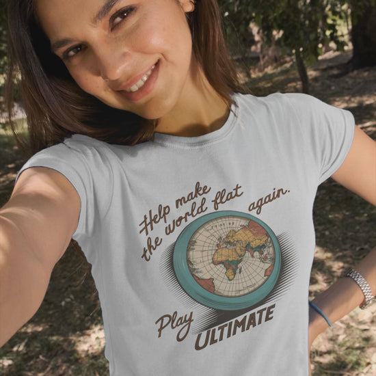 a video of woman sporting a  t-shirt with a flying frisbee of the world printed on it with the caption Help Make The World Flat Again Play Ultimate