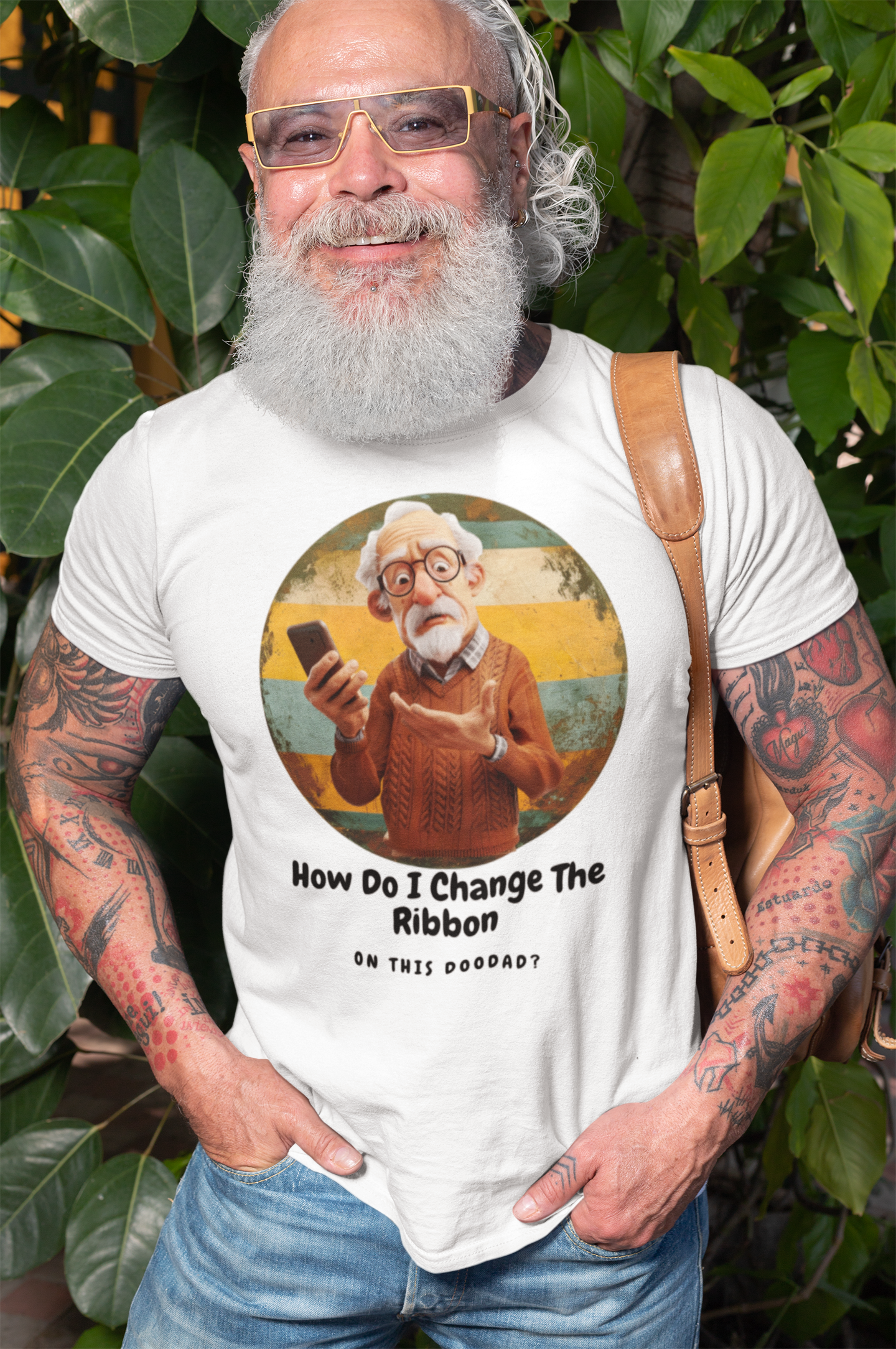 a senior man wearing t shirt of a grandpa holding a phone with the caption How Do I Change The Ribbon On this Doodad