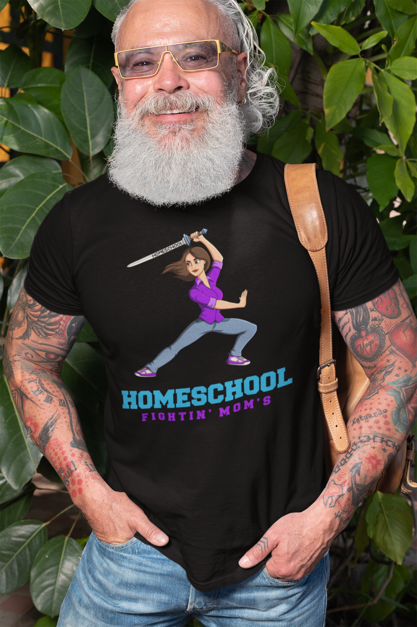 an senior man wearing at-shirt with a illustration of mom branding a sword with the slogan Homeschool Fightin' Mom's