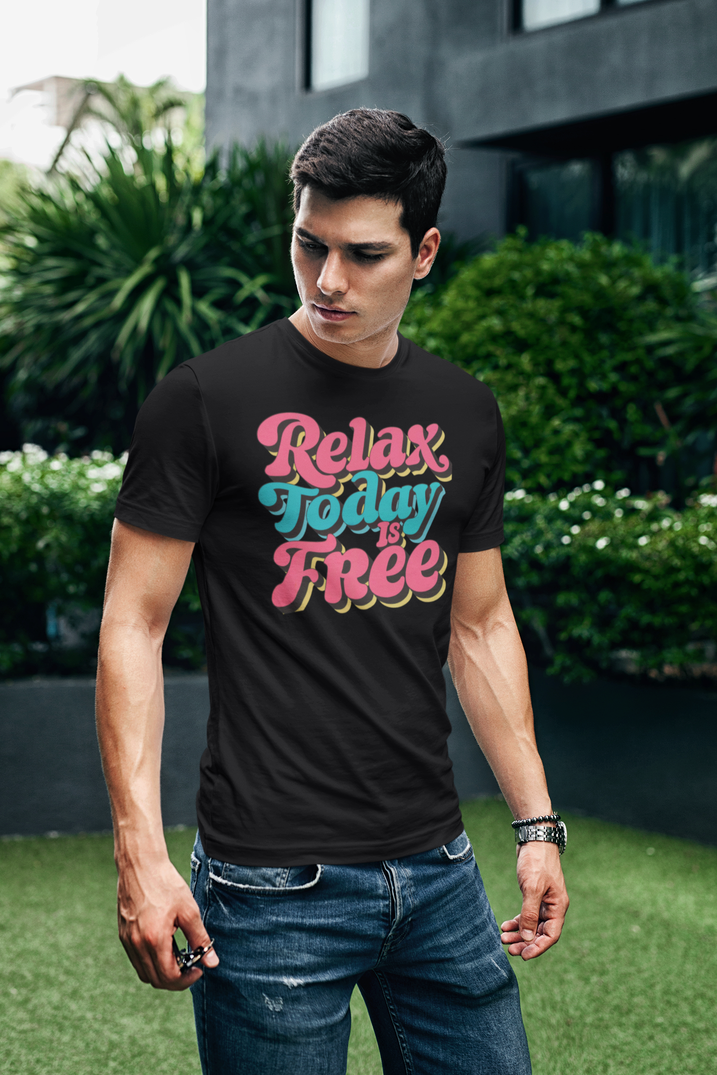 a young man wearing a retro t shirt with the words Relax Today Is Free