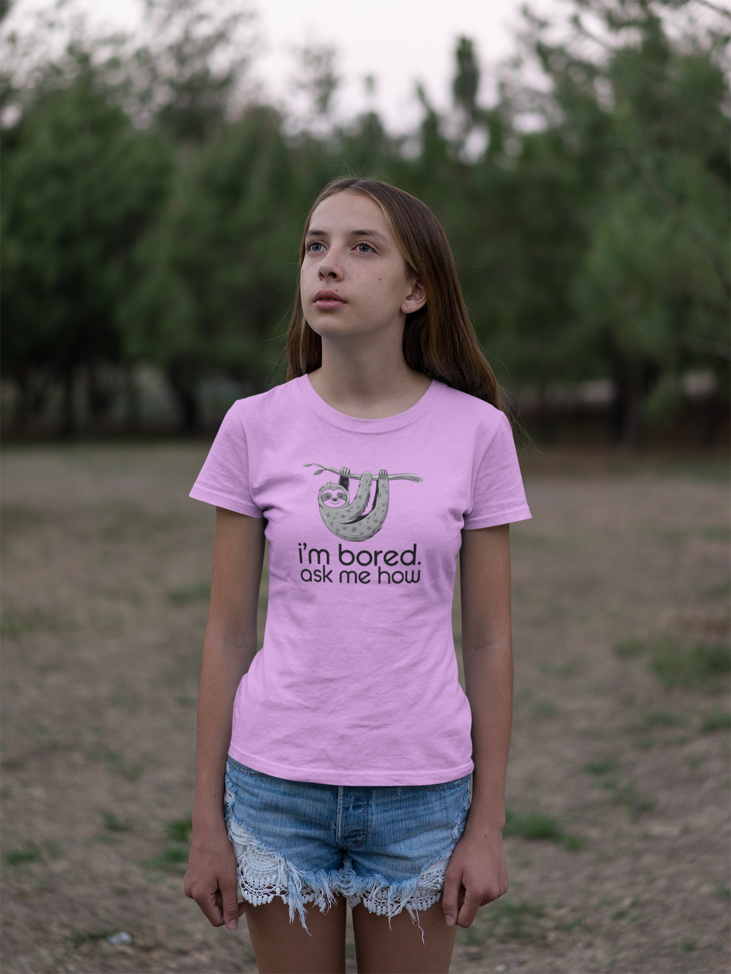a girl with a bored look wearing I'm Bored Ask Me How Sloth Shirt she got as a gift