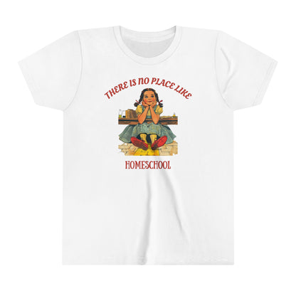 a kids t shirt a girl smiling above golden bricks with the slogan there is no place like homeschool