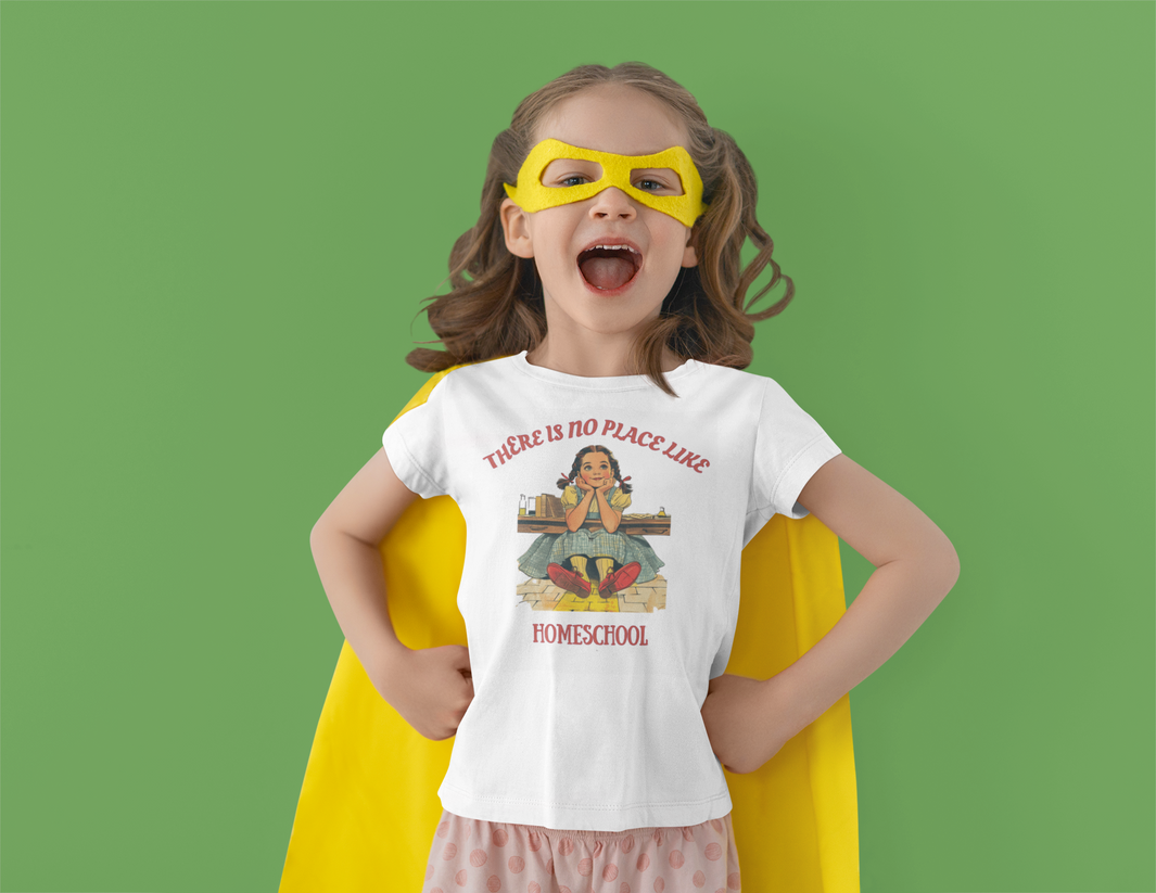 a young girl in a yellow robe with a white t shirt with the caption there is no place like homeschool