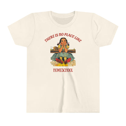a kids t shirt a girl smiling above golden bricks with the slogan there is no place like homeschool